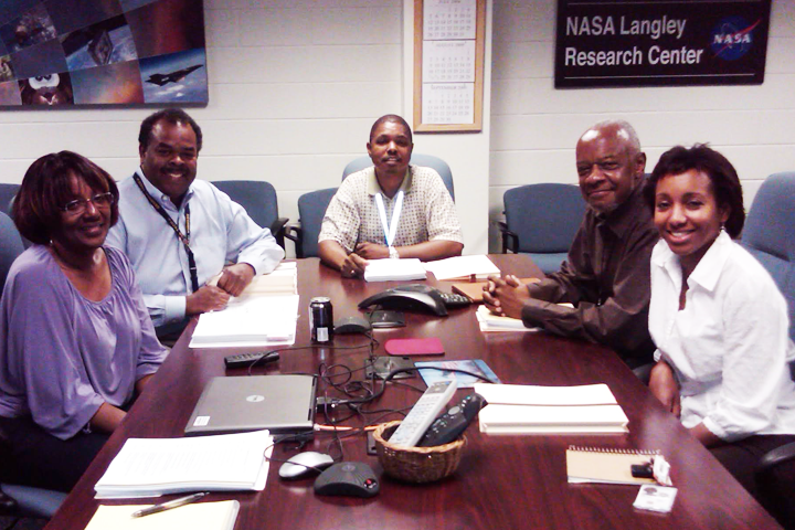 Melvin Ferebee, Gloria Evans, and others around a table planning education programs for African-American K-12 students